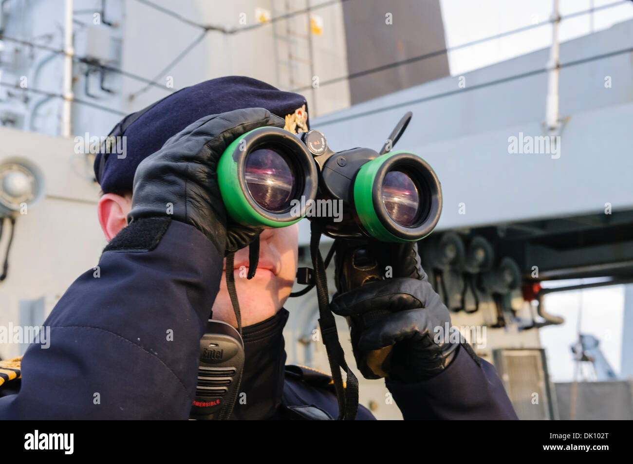 Belfast, Northern Ireland. 30th Nov 2013 - Royal Navy sailor looks out to sea using binoculars. Credit:  Stephen Barnes/Alamy Live News Stock Photo