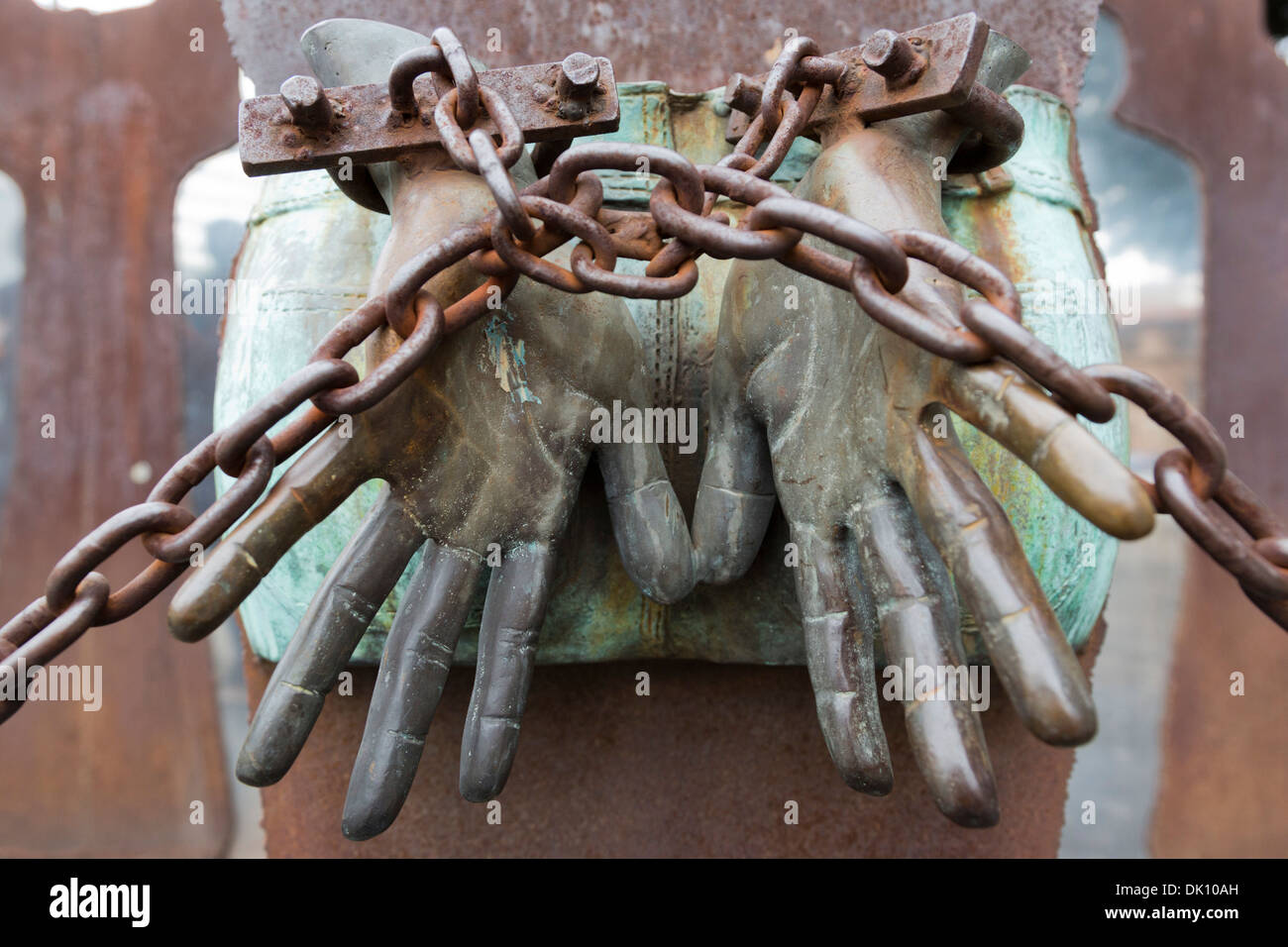 Hands in rusty chains, statue against fascism near the train station of Ostiense, Rome, Italy Stock Photo