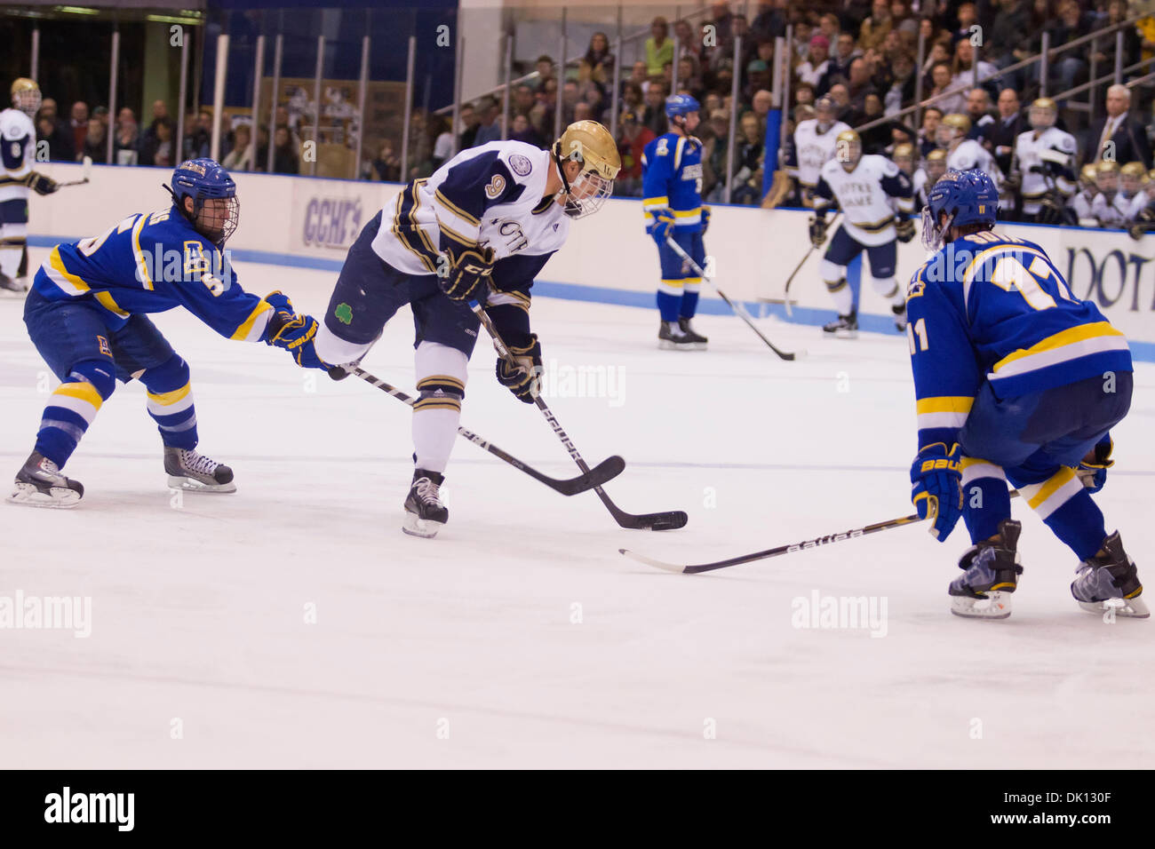 Jan. 14, 2011 - South Bend, Indiana, United States of America - Notre Dame center Anders Lee (#9) shoots the puck as Alaska defensemen Joe Sova (#11) and Aaron Gens (#5) defend in 3rd action during NCAA hockey game between Alaska and Notre Dame.  The Notre Dame Fighting Irish defeated the Alaska Nanooks 2-1 in game at Joyce Center in South Bend, Indiana. (Credit Image: © John Mersi Stock Photo