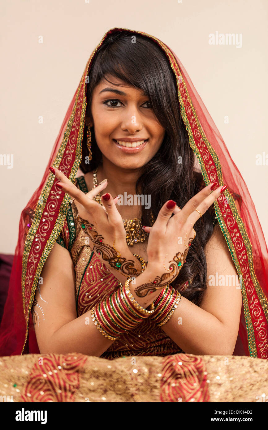 Portrait of an Indian woman wearing a sari and henna tattoos on her