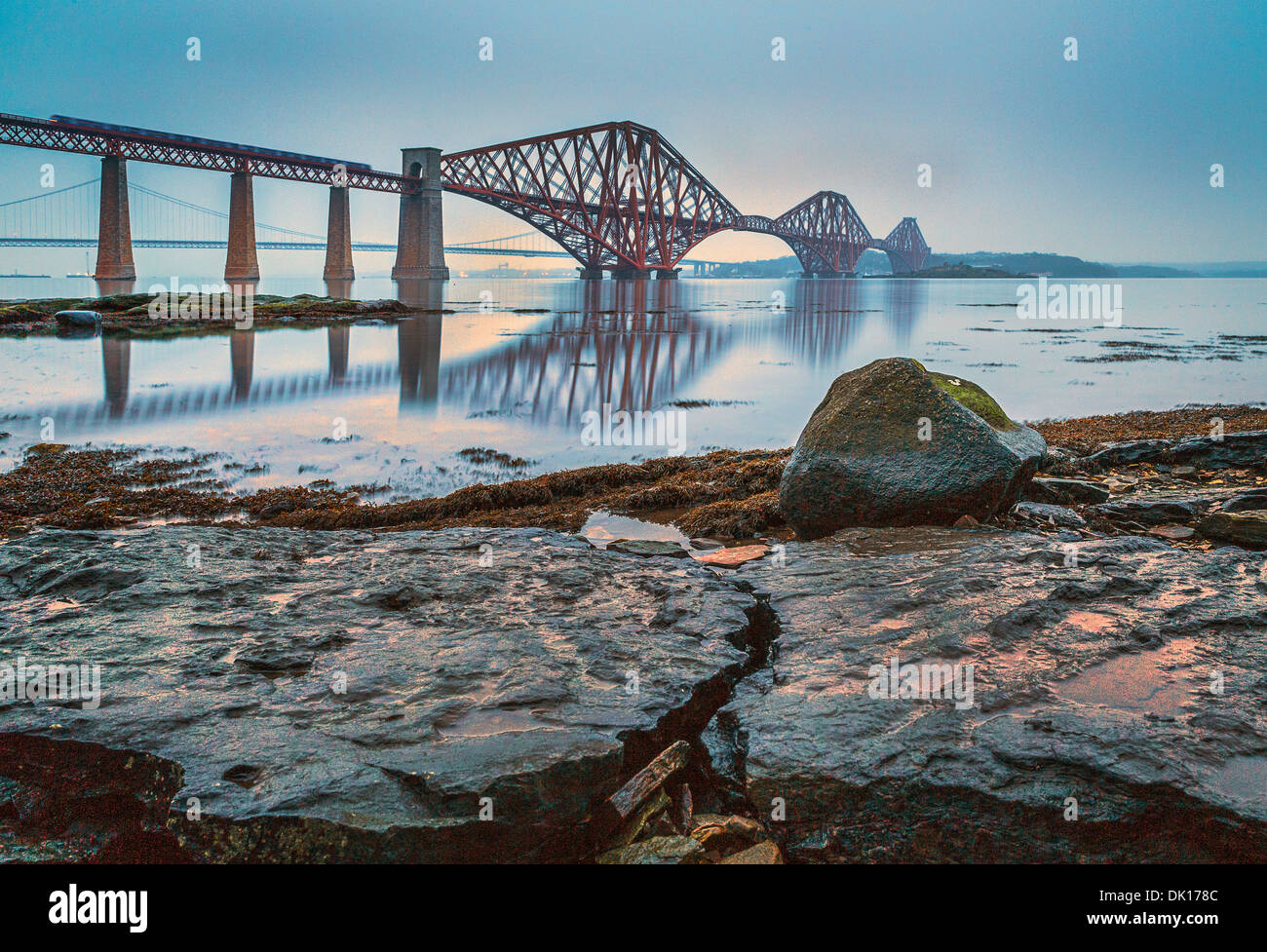 The Forth Rail and Road Bridges on a relatively calm cloudy day as seen from South Queensferry, Scotland Stock Photo