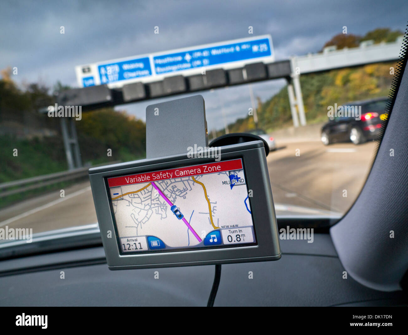 Satellite Navigation screen in car on M25 Orbital motorway with red 'Variable Safety Camera Zone' alert displayed Surrey UK Stock Photo