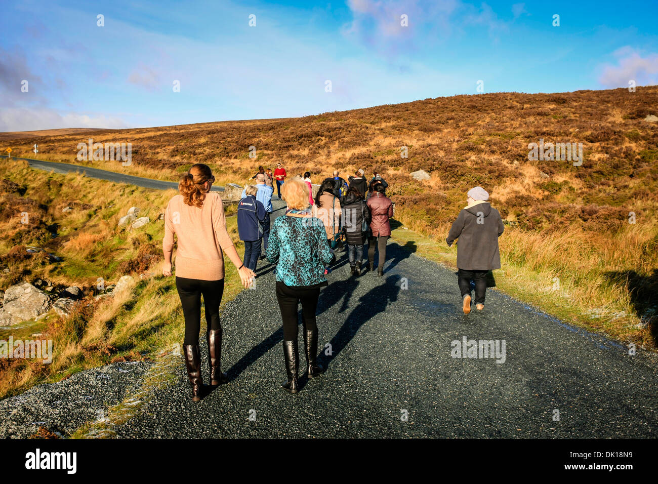 People walking on a high mountain road in Wicklow Eire Stock Photo