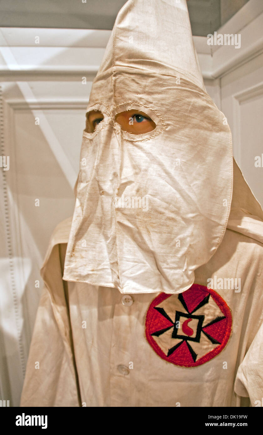 Ku Klux Klan white robe with common insignia and pointed hood at History Museum of Mobile. Stock Photo
