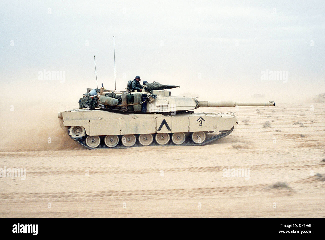 A US Army M-1A1 Abrams main battle tank from the 3rd Brigade, 1st Armored Division, moves across the desert in northern Kuwait during Operation Desert Storm February 28, 1991 in Kuwait. Staff Sgt. Robert Reeve Stock Photo