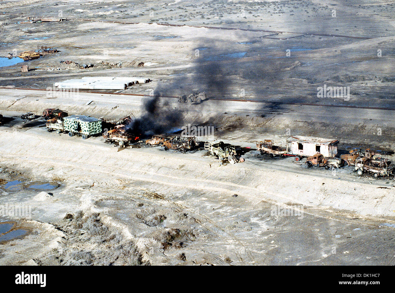 Aerial view of demolished Iraqi military vehicles destroyed by coalition forces along a roadway in the Euphrates River Valley in the aftermath of Operation Desert Storm March 4, 1991 in Iraq. Stock Photo