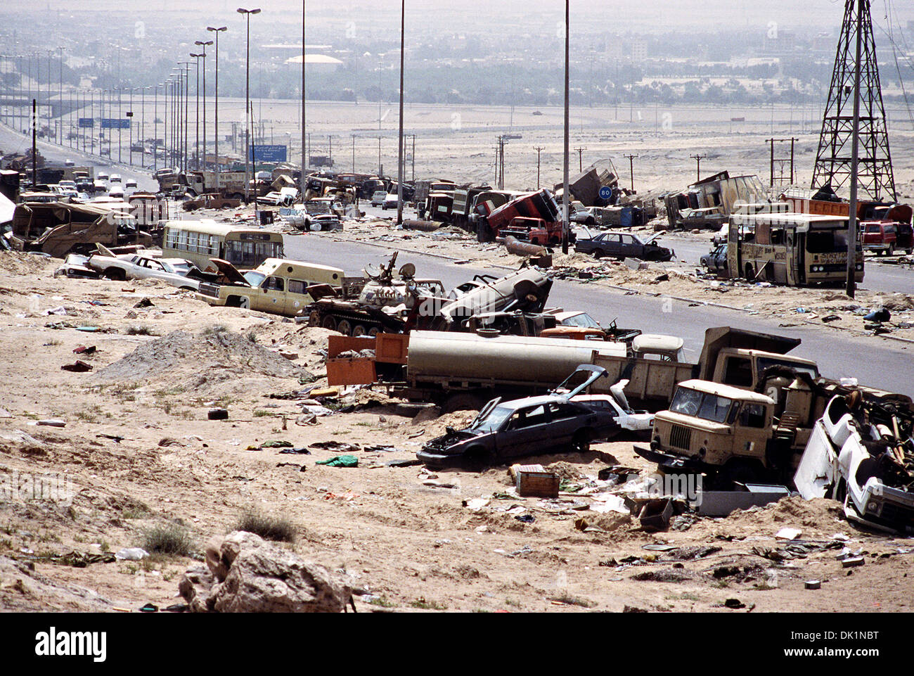 Demolished vehicles litter Kuwait Highway 8, the route fleeing Iraqi forces took as they retreated from Kuwait during Operation Desert Storm April 18, 1991 in Kuwait. The road is known as the 'highway of death' because of the number of vehicles destroyed by allied forces. Stock Photo