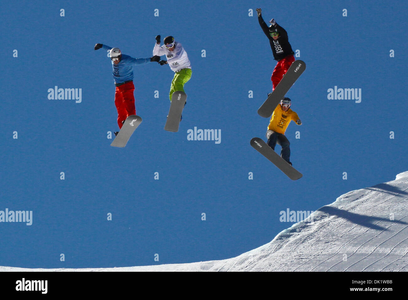 Jan. 29, 2011 - Aspen, Colorado, U.S. - NICK BAUMGARTNER (L) leads the pack over the last jump at the Winter X-Games Snowboarder X Finals. Baumgartner, riding with a broken collarbone, brought home the gold. (Credit Image: © Rustin Gudim/ZUMAPRESS.com) Stock Photo