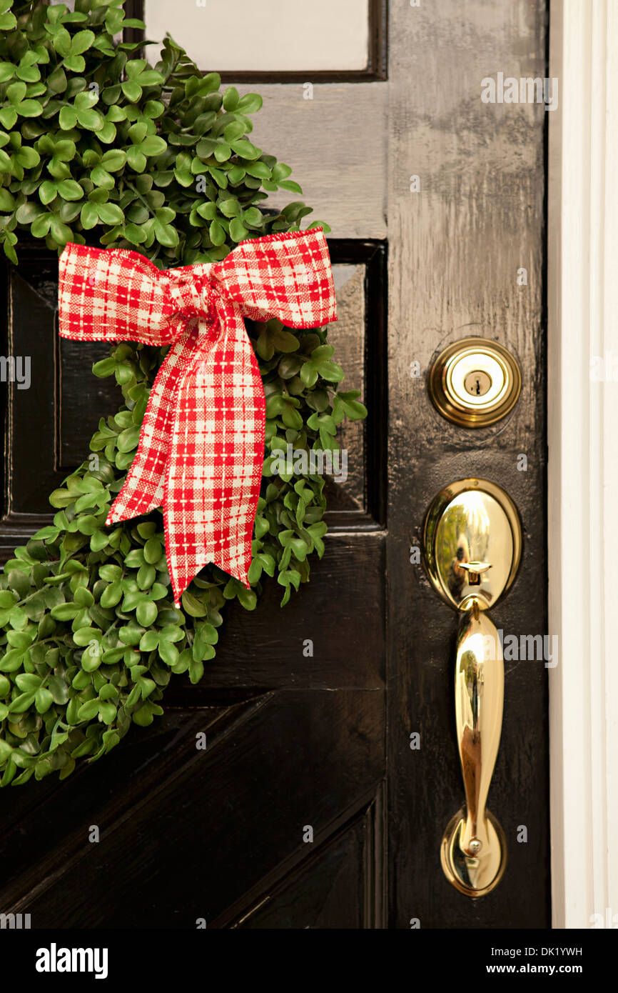 Close up of red and white gingham ribbon on Christmas wreath hanging