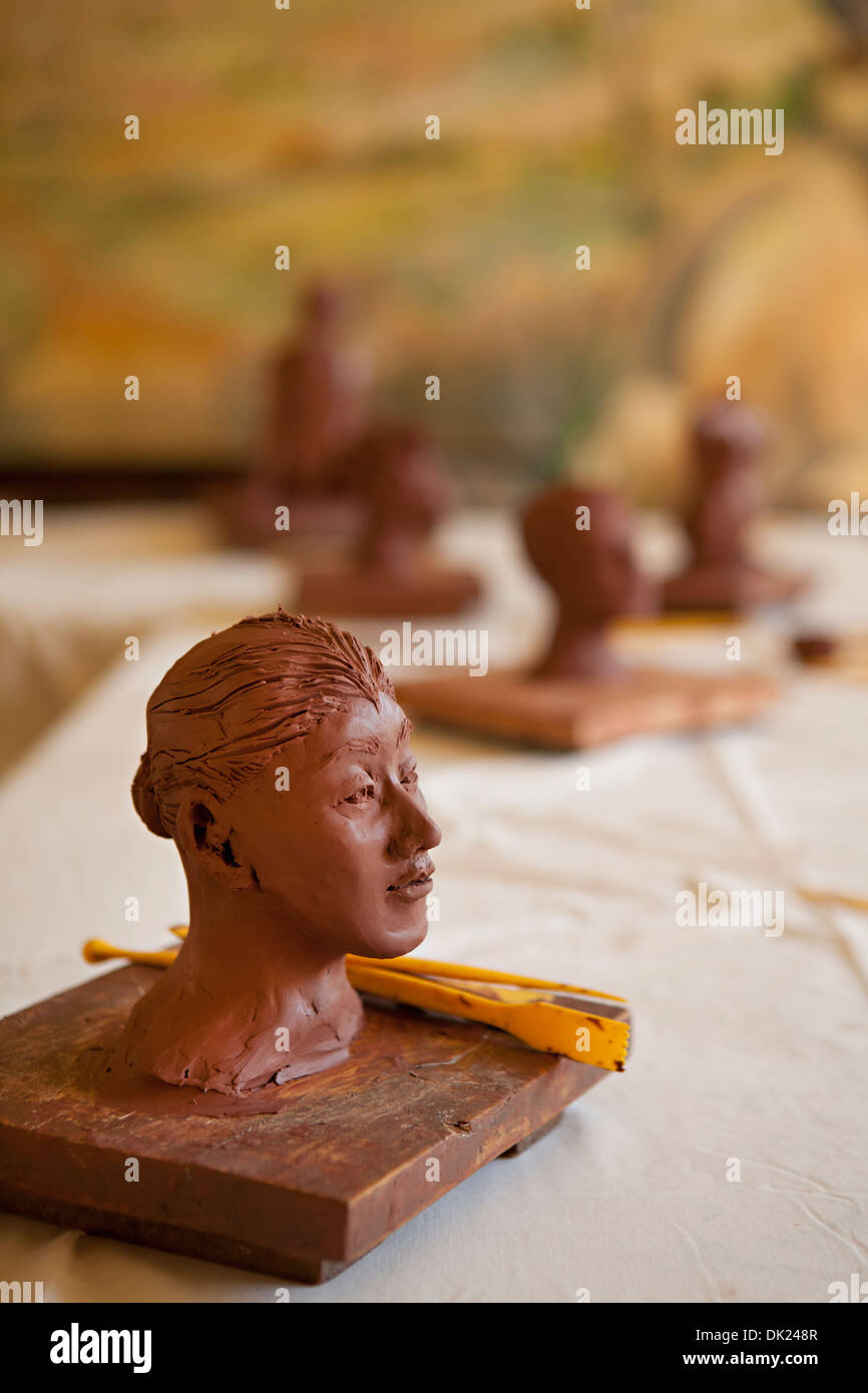 Close up of clay female likeness face in sculpture classroom Stock Photo