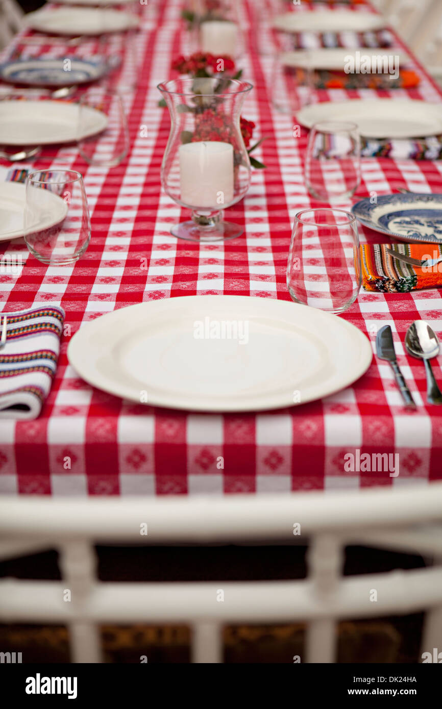 Place settings on red and white checkered tablecloth Stock Photo