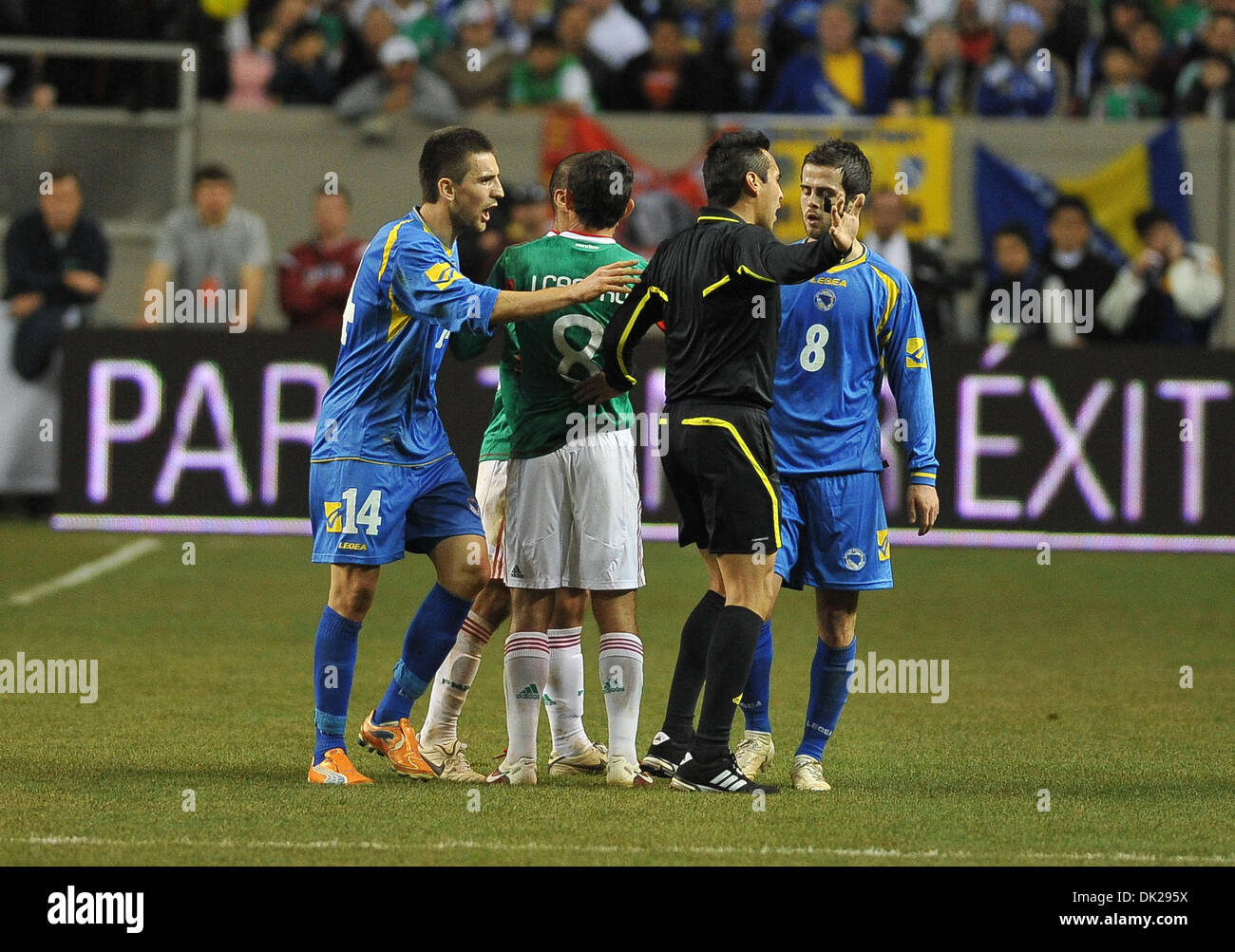Feb. 9, 2011 - Atlanta, Georgia, United States of America - Referee Jair Marrufo tries to make the call as Bosnia-Herzegovina's Forward Vedad Ibisevic (#14) and Bosnia-Herzegovina's Midfielder Miralem Pjanic (#8) protest during Soccer action between Bosnia-Herzegovina and Mexico.  Mexico defeated Bosnia-Herzegovina 2-0 in the game at the Georgia Dome in Atlanta, GA. (Credit Image:  Stock Photo