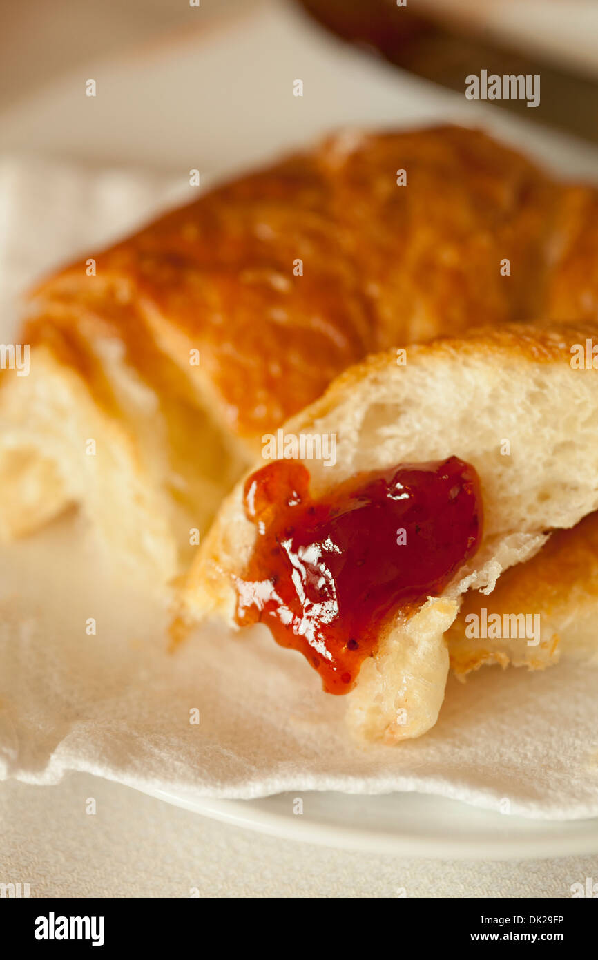 Close up of breakfast croissant with strawberry jam Stock Photo