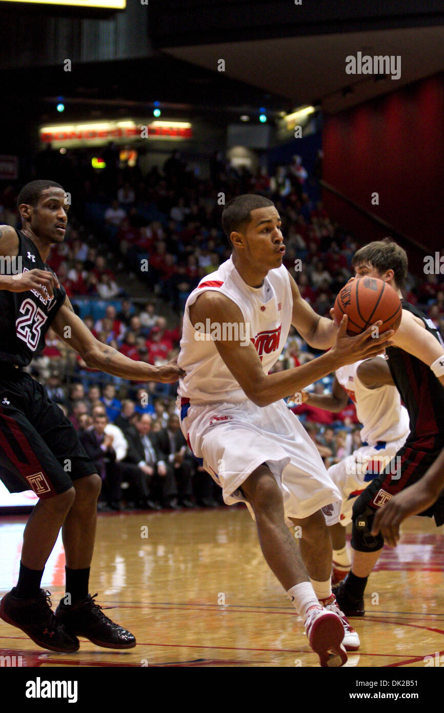 Feb. 12, 2011 - Dayton, Ohio, U.S.A - Dayton Flyers forward Devin Oliver (5) looks for an open man to pass to between Temple Owls guard Ramone Moore (23) and guard Juan Fernandez (4) in the second half of the game between Temple and Dayton at the UD Arena, Dayton, Ohio.  Temple defeated Dayton 75-63. (Credit Image: © Scott Stuart/Southcreek Global/ZUMAPRESS.com) Stock Photo