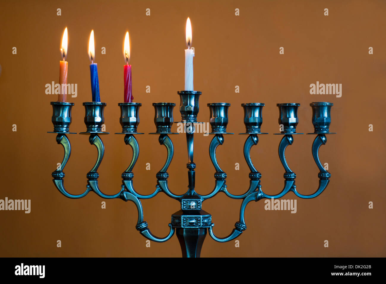 Hanukkah menorah with four burning candles on the third day of Stock