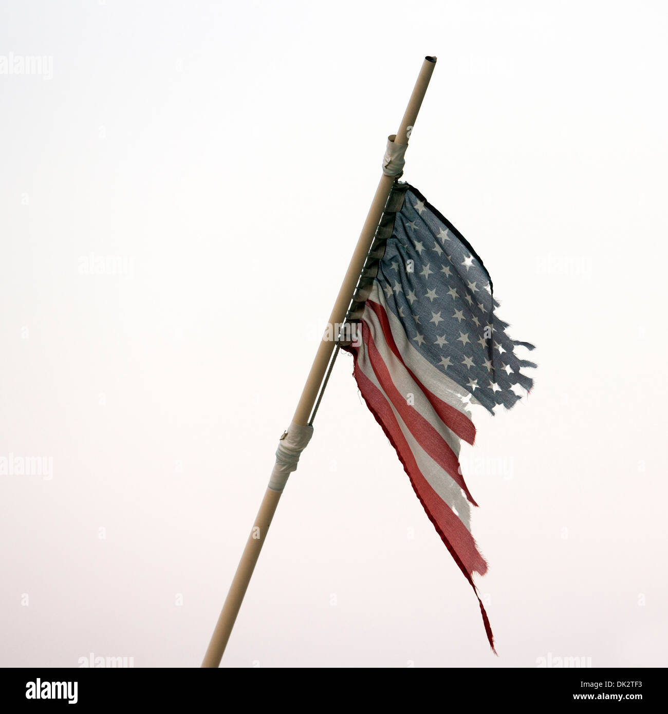 Torn American Flag on flag pole Stock Photo