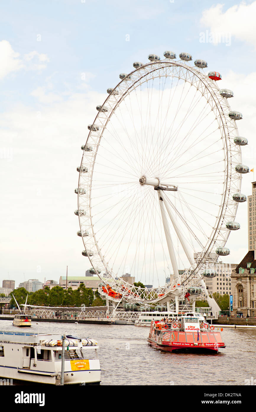 Boats on Thames River in front of the London Eye Ferris Wheel, London, England, United Kingdom Stock Photo