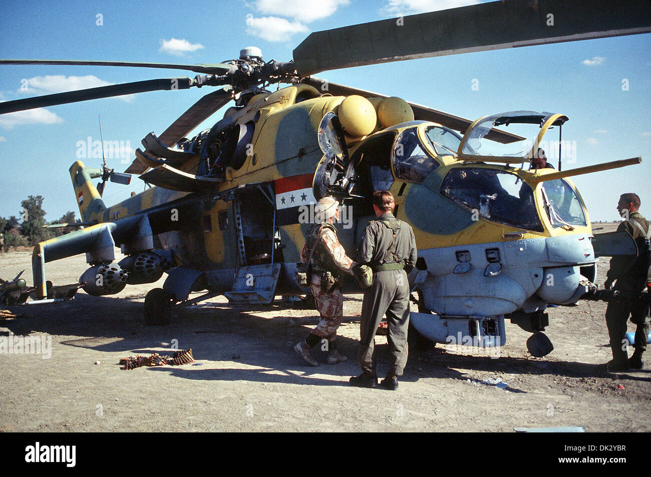 US soldiers with the 82nd Airborne Division inspect an Iraqi MIL Mi-24 Hind-D assault helicopter abandoned during Operation Desert Storm March 4, 1991 in Kuwait. Stock Photo