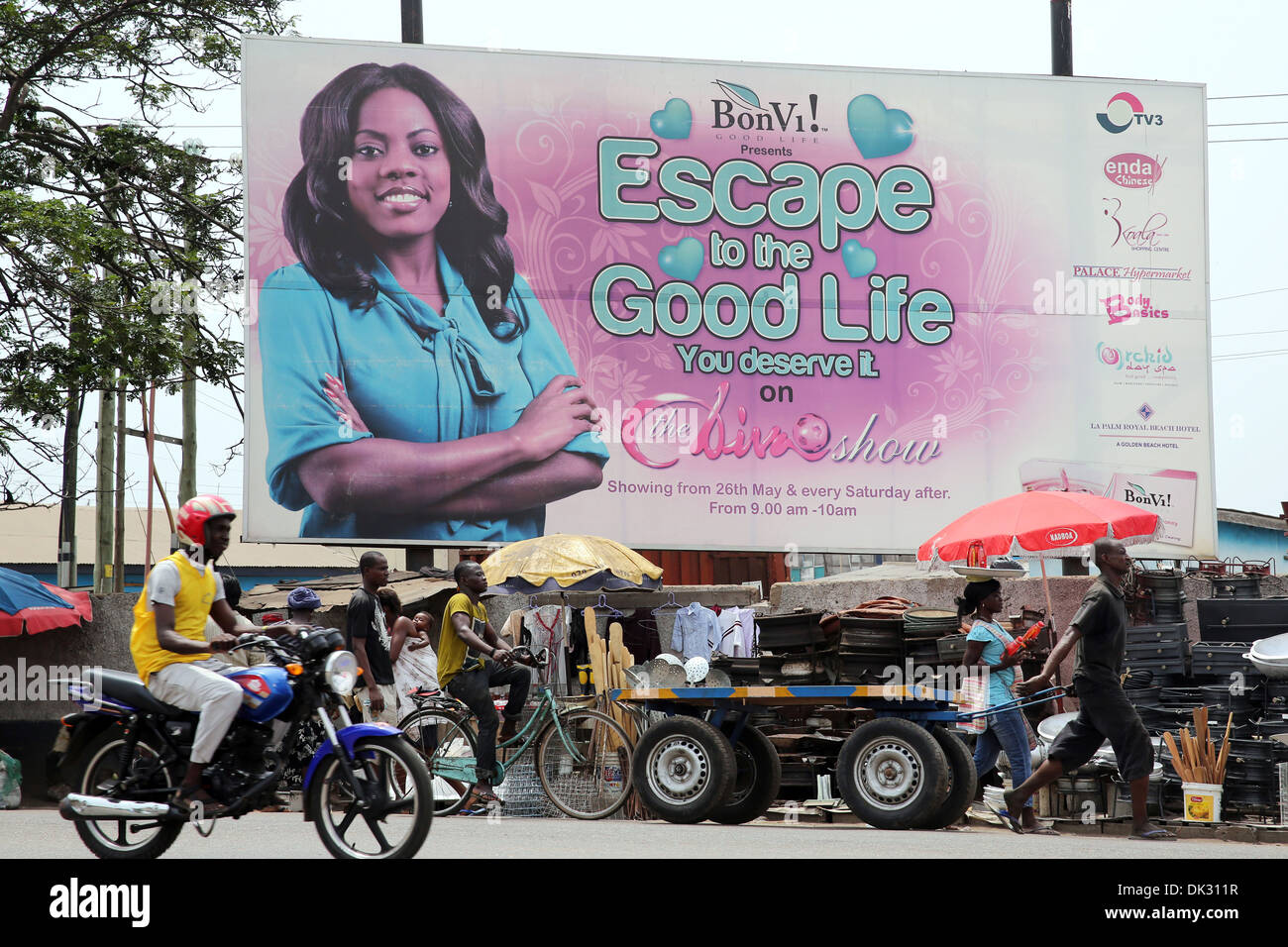 Billboard shows a beauty model promising GOOD LIFE near the Agbogbloshie slum in Accra, capital of Ghana, West Africa Stock Photo