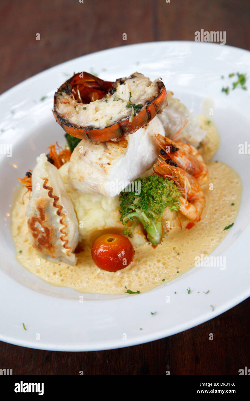 Moqueca Castanha dish, a stew with fish, shrimps and lobster served with mashed potatoes at Castanha restaurant, Cumbuco, brazil Stock Photo