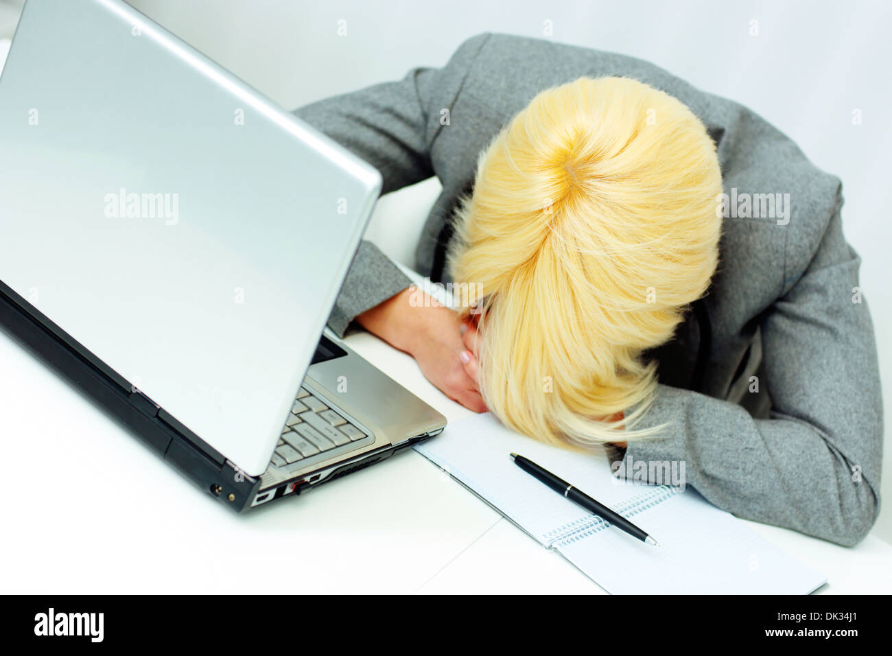 Young tired businesswoman sleeping at her workplace in office Stock ...