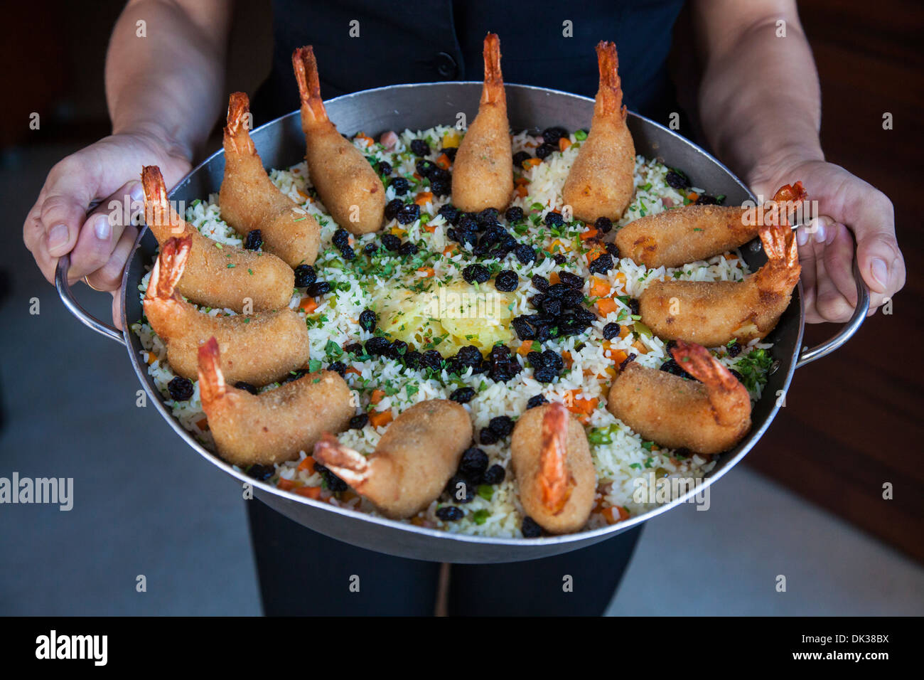 Waiter with Camaroes Jangaderiro dish at Coco Bambu Frutos do Mar restaurant, Fortaleza, Brazil. Stock Photo