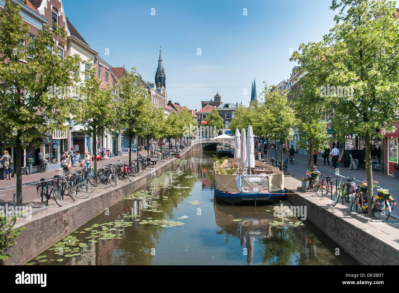 the dutch city Delft with canals bikes shops and people Stock Photo