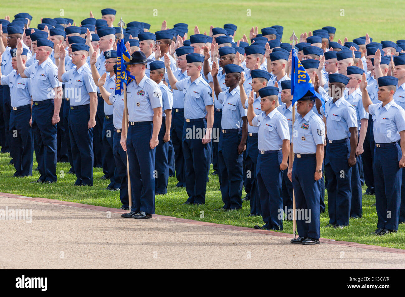 Flight of airmen in dress blues being sworn into service during USAF basic training graduation In San Antonio, Texas Stock Photo