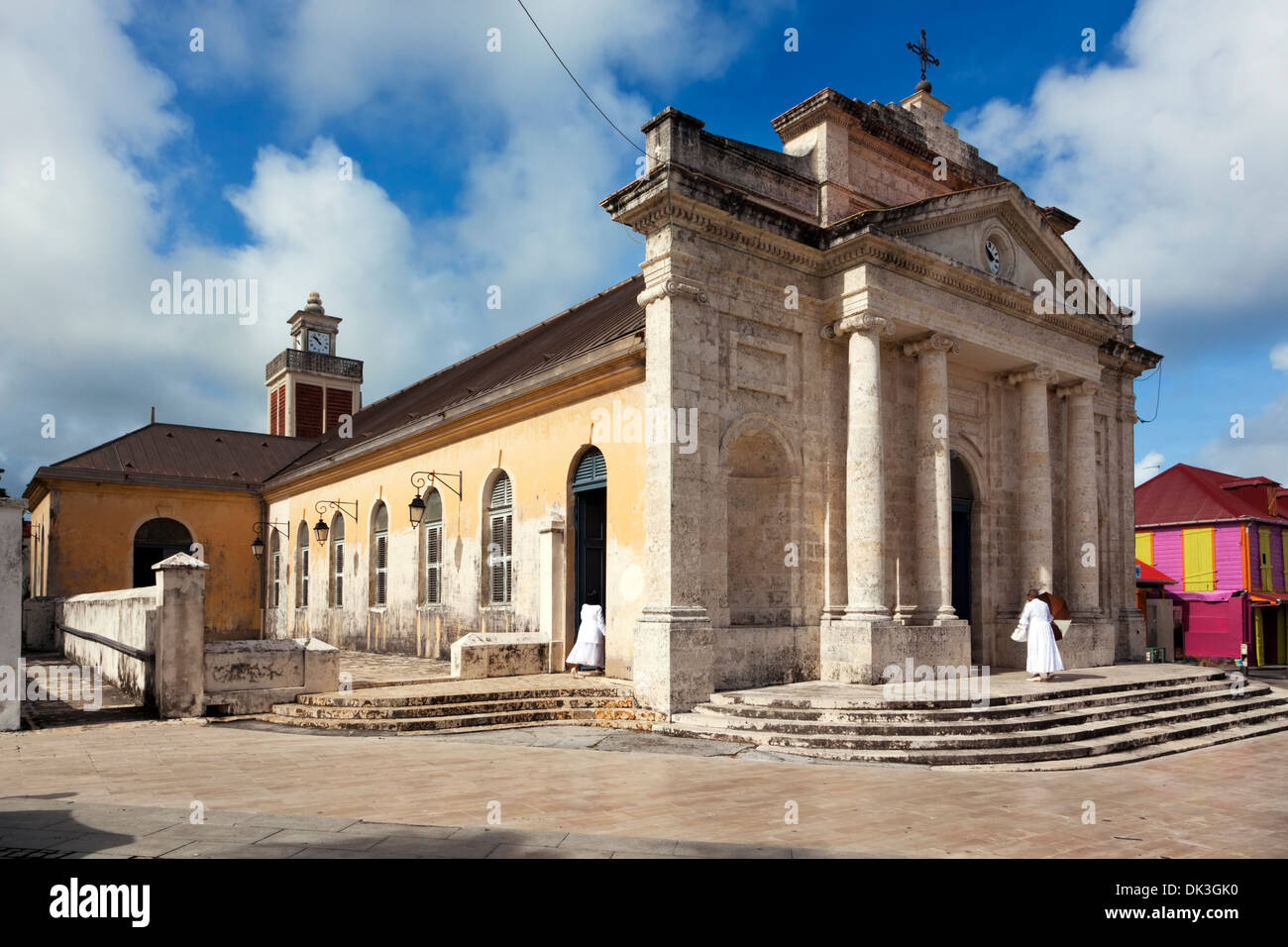 Two elder ladies in white dresses visiting Saint Jean Baptiste church at Le Moule, Guadeloupe, for worship on All Saint's Day Stock Photo