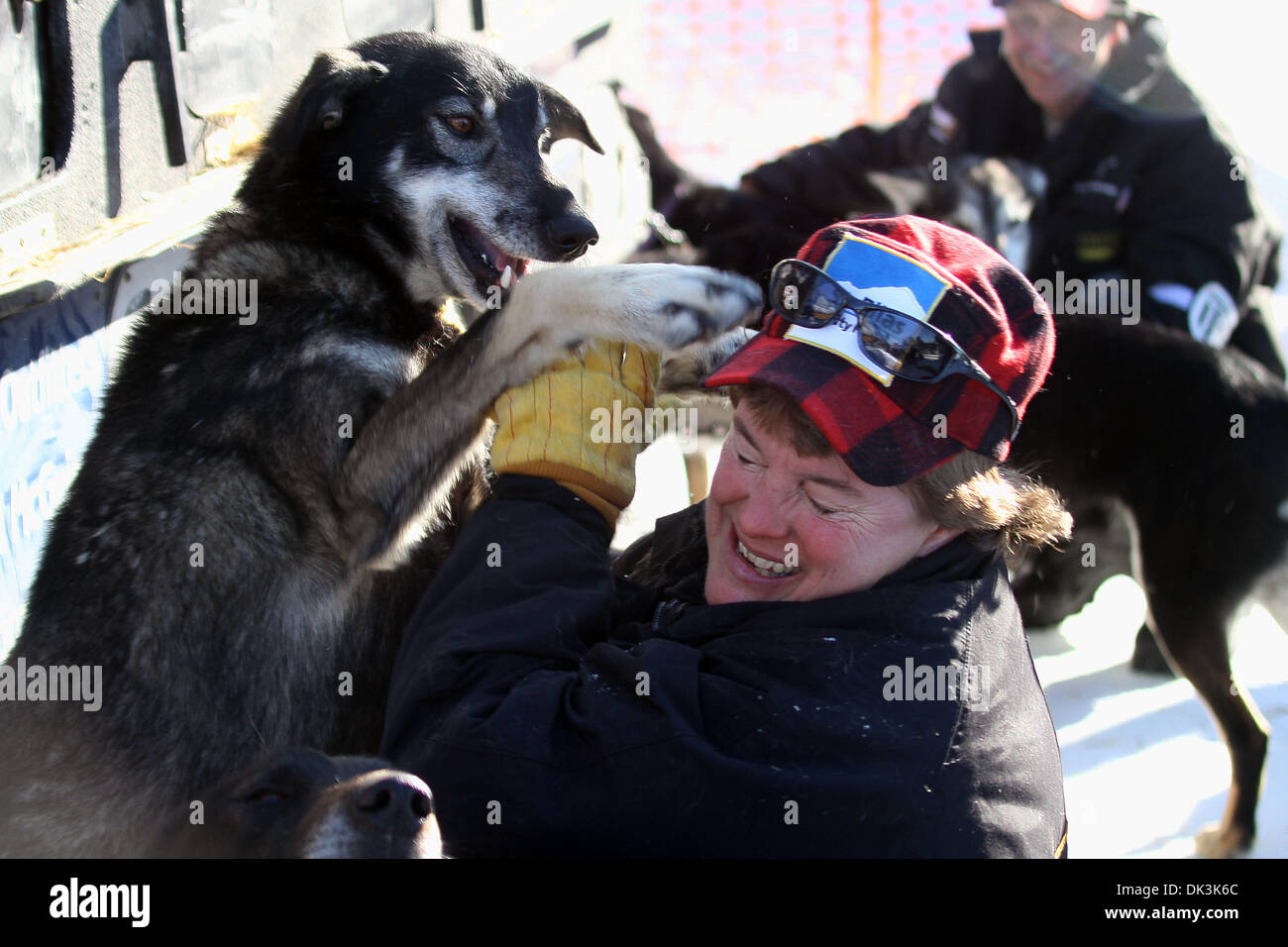Martin Buser Mar 06, 2011 - Willow, Alaska, U.S. - SUE ALLEN gets a greeting from ...