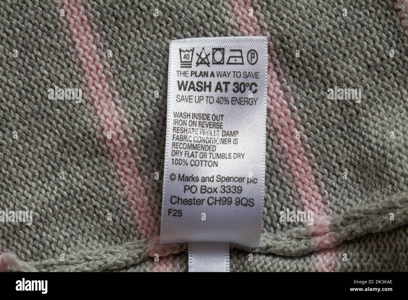 label in Marks & Spencer garment - The Plan A way to save wash at 30 degrees C save up to 40% energy - care washing symbols and instructions Stock Photo