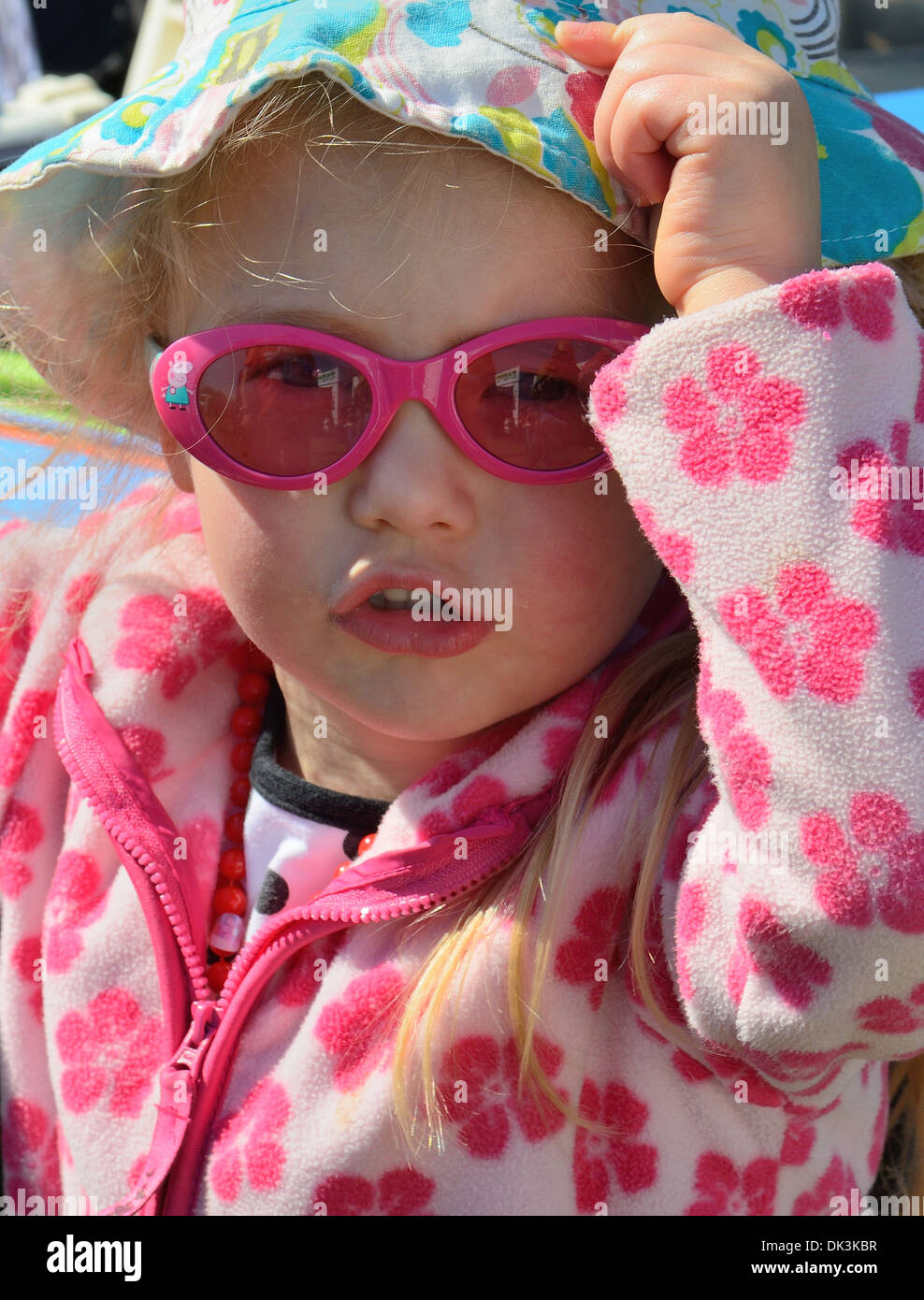 Cute little baby girl wearing cool pink sun glasses doing super model poses  Stock Photo - Alamy