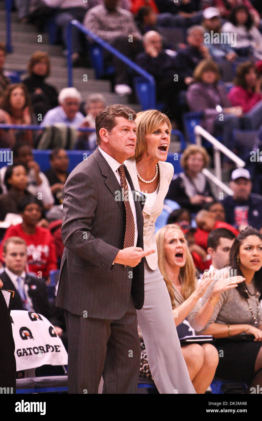 Connecticut associate head coach Chris Dailey does her best, in vain, to  keep head coach Geno Auriemma from picking up a technical foul from  official Joseph Vaszily late in the first half