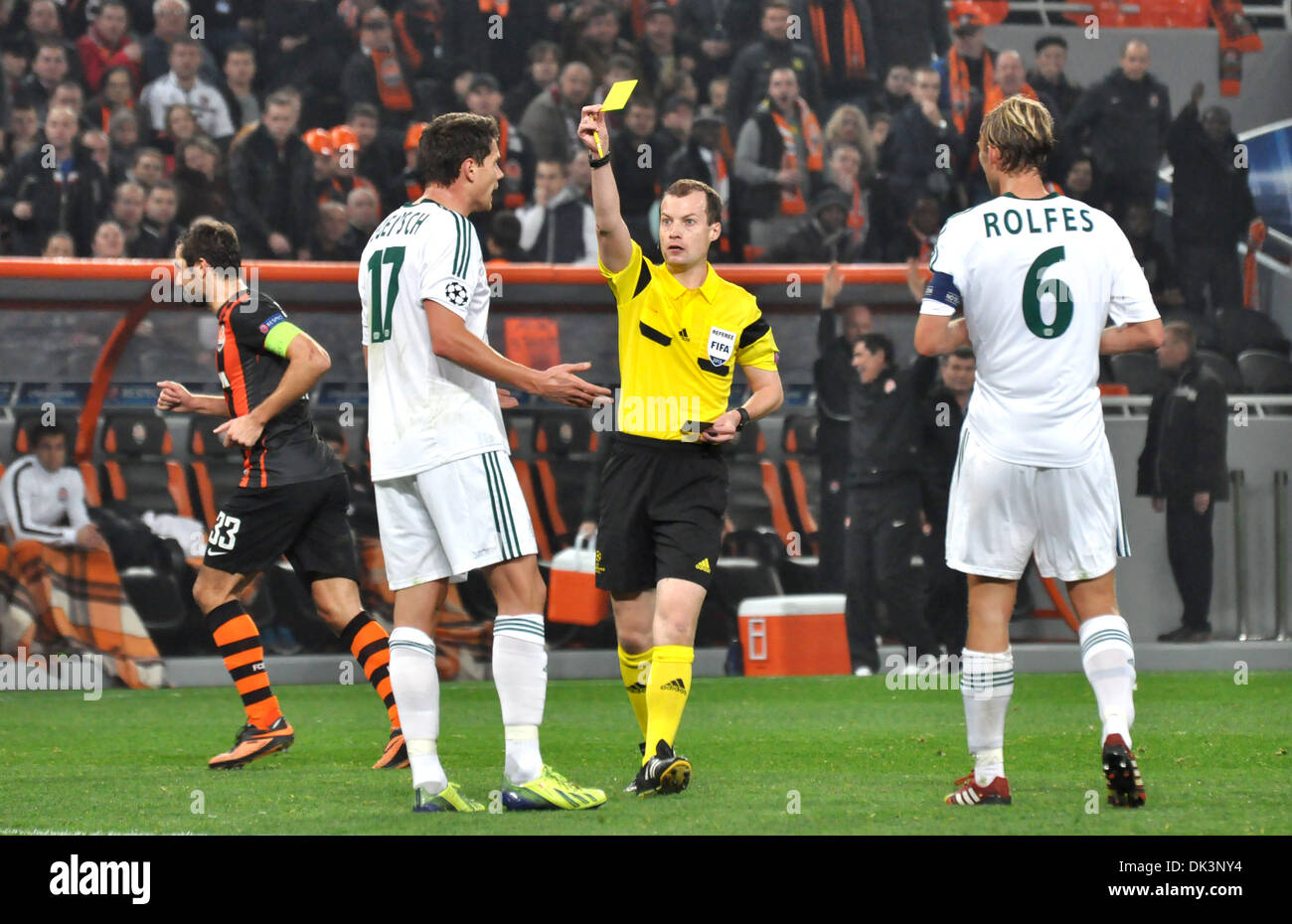 Referee shows yellow card during the match between Shakhtar