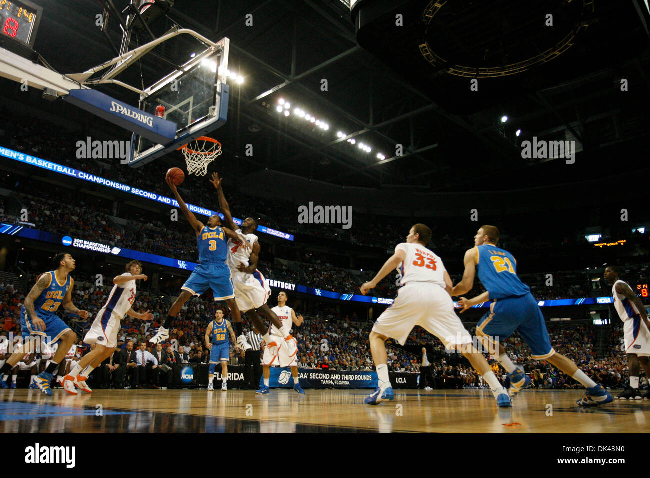 Mar. 19, 2011 - Tampa - CHRIS ZUPPA   |   Times.SP 335803 ZUPP NCAA 1.(Tampa, 03/19/2011) UCLA's Malcolm Lee shoots with Florida's Patric Young defending. 2011 NCAA Basketball tournament at the St. Petersburg Times Forum. 12:15 p.m. game is No. 5 West Virginia vs. No. 4 Kentucky. The second game is No. 7 UCLA vs. No. 2 Florida. [CHRIS ZUPPA, Times] (Credit Image: © St. Petersburg T Stock Photo
