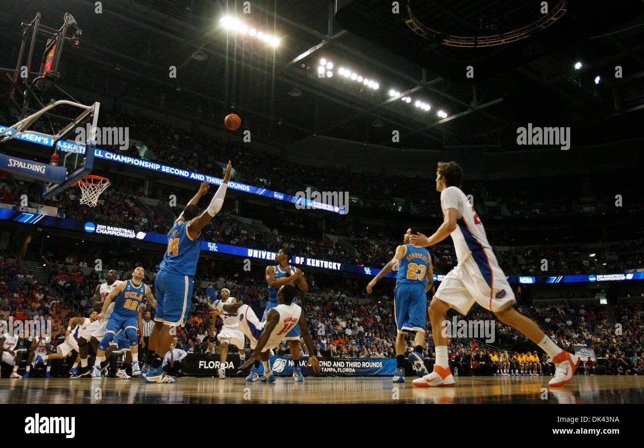 Mar. 19, 2011 - Tampa - CHRIS ZUPPA   |   Times.SP 335803 ZUPP NCAA 10.(Tampa, 03/19/2011) Florida's Erving Walker (11-falling backward) makes a shot while off balance and with two UCLA defenders on him in the second half. 2011 NCAA Basketball tournament at the St. Petersburg Times Forum. 12:15 p.m. game is No. 5 West Virginia vs. No. 4 Kentucky. The second game is No. 7 UCLA vs. N Stock Photo