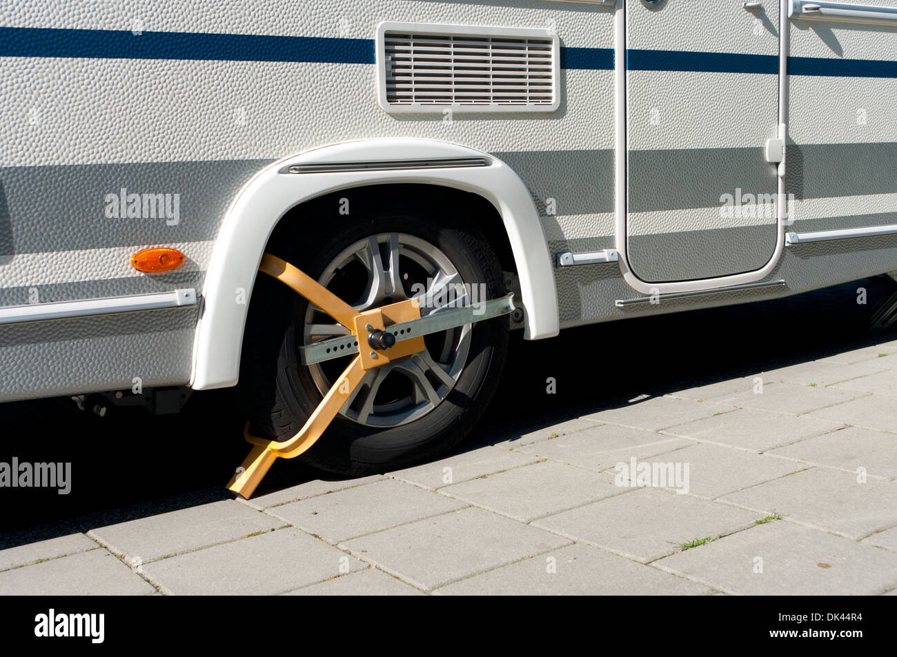 wheel clamp on a mobile home to prevent it from theft Stock Photo