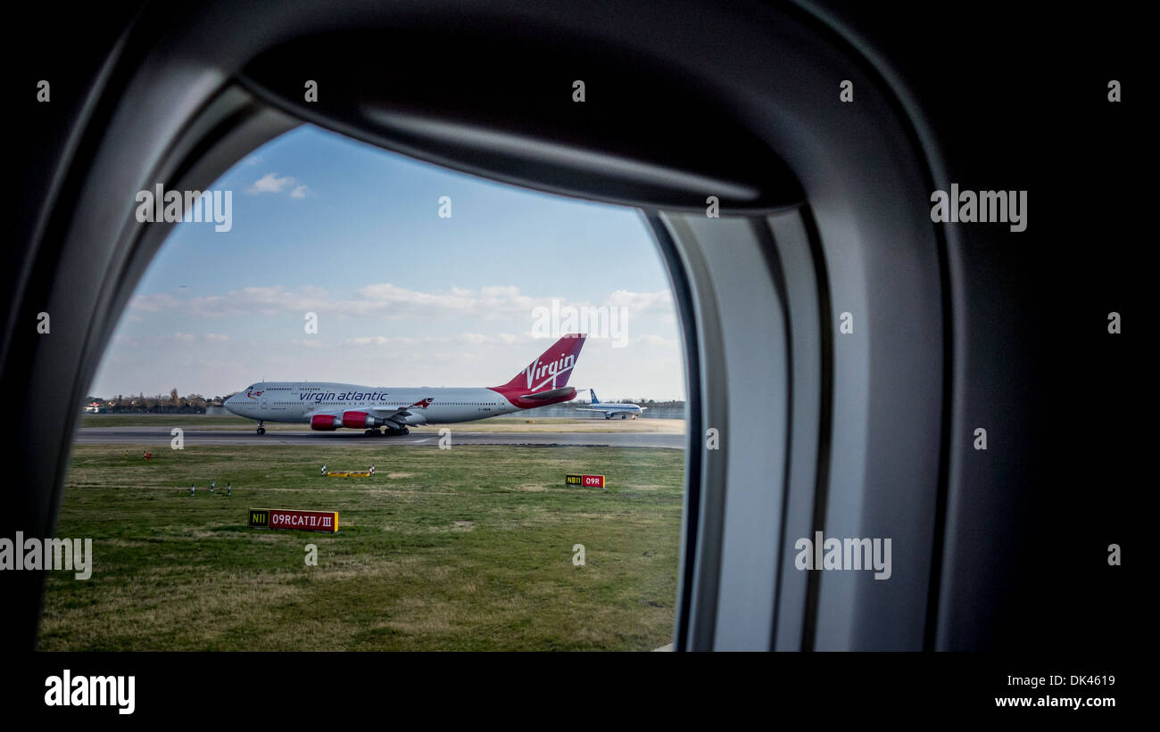 View of a Virgin airplane through an airplane window Stock Photo