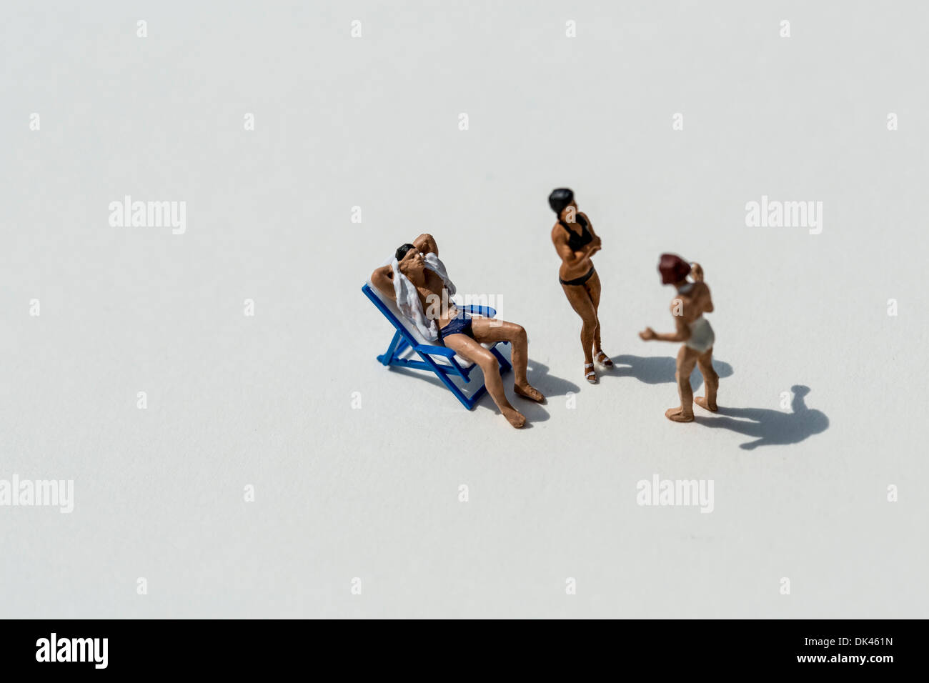 Figurines on a white background socializing at the beach club Stock Photo