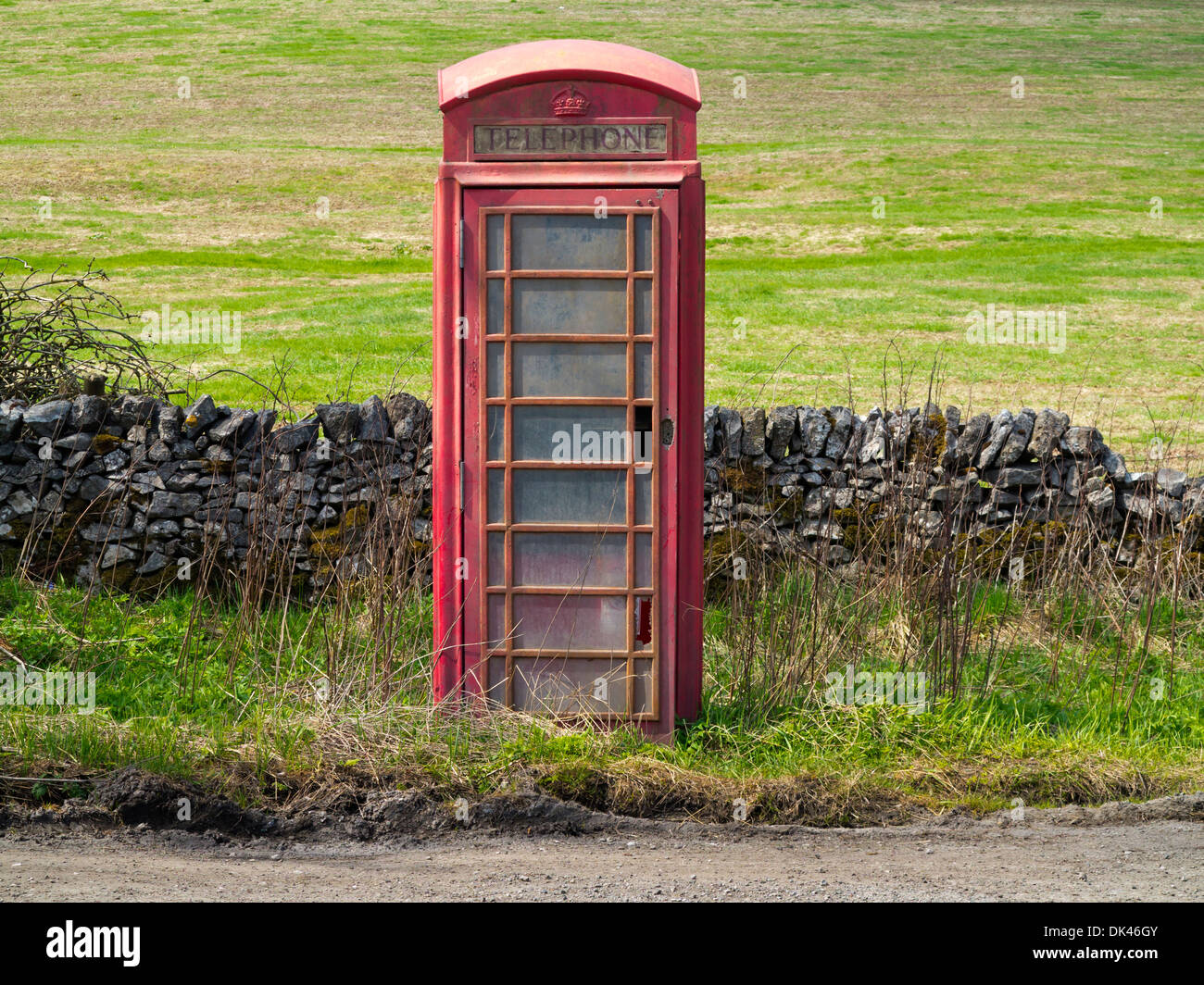 Disused traditional British red telephone box on road near Ashbourne in the Peak District National Park Derbyshire England UK Stock Photo