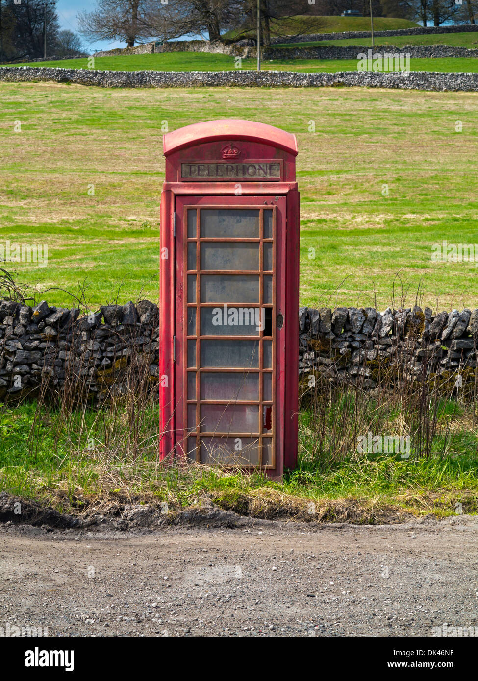 Disused traditional British red telephone box on road near Ashbourne in the Peak District National Park Derbyshire England UK Stock Photo
