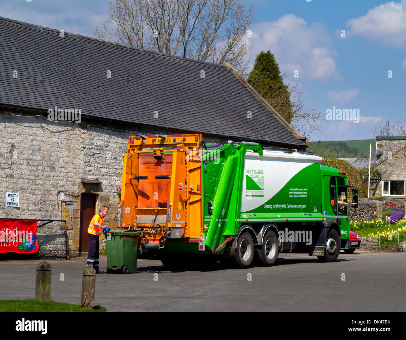 Serco outsourced dustcart with refuse collector operated on behalf of Derbyshire Dales District Council Hartington Derbyshire UK Stock Photo