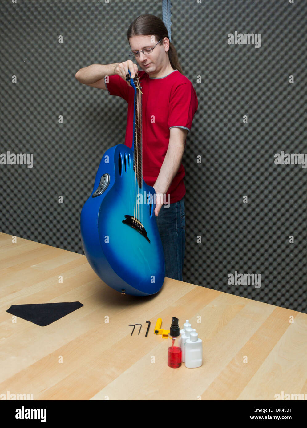 Guitar technician checking the electro-acoustic guitar ( Series with the same model available) Stock Photo