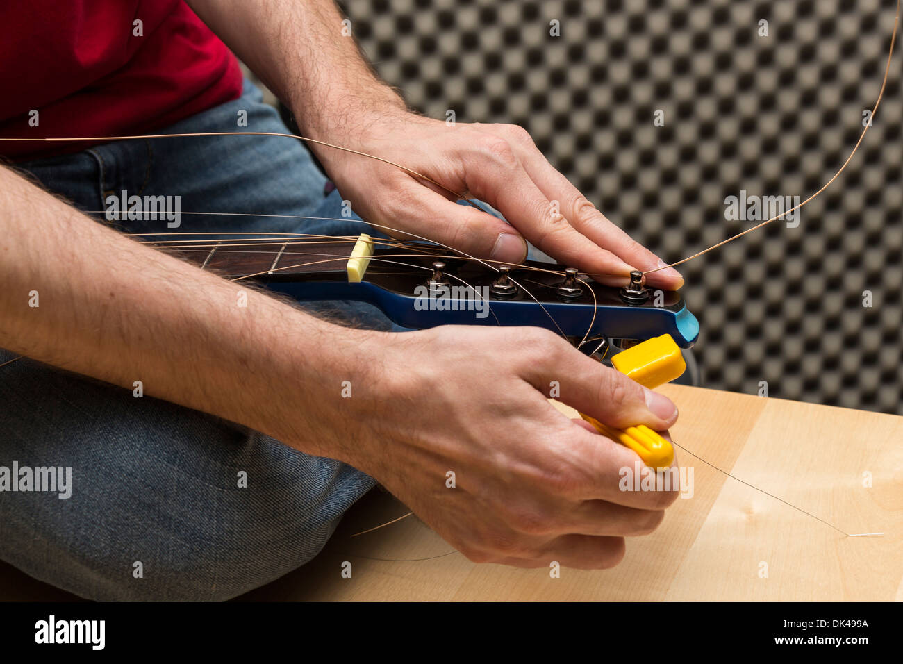 Guitarist tuning the guitar ( Series with the same model available) Stock Photo