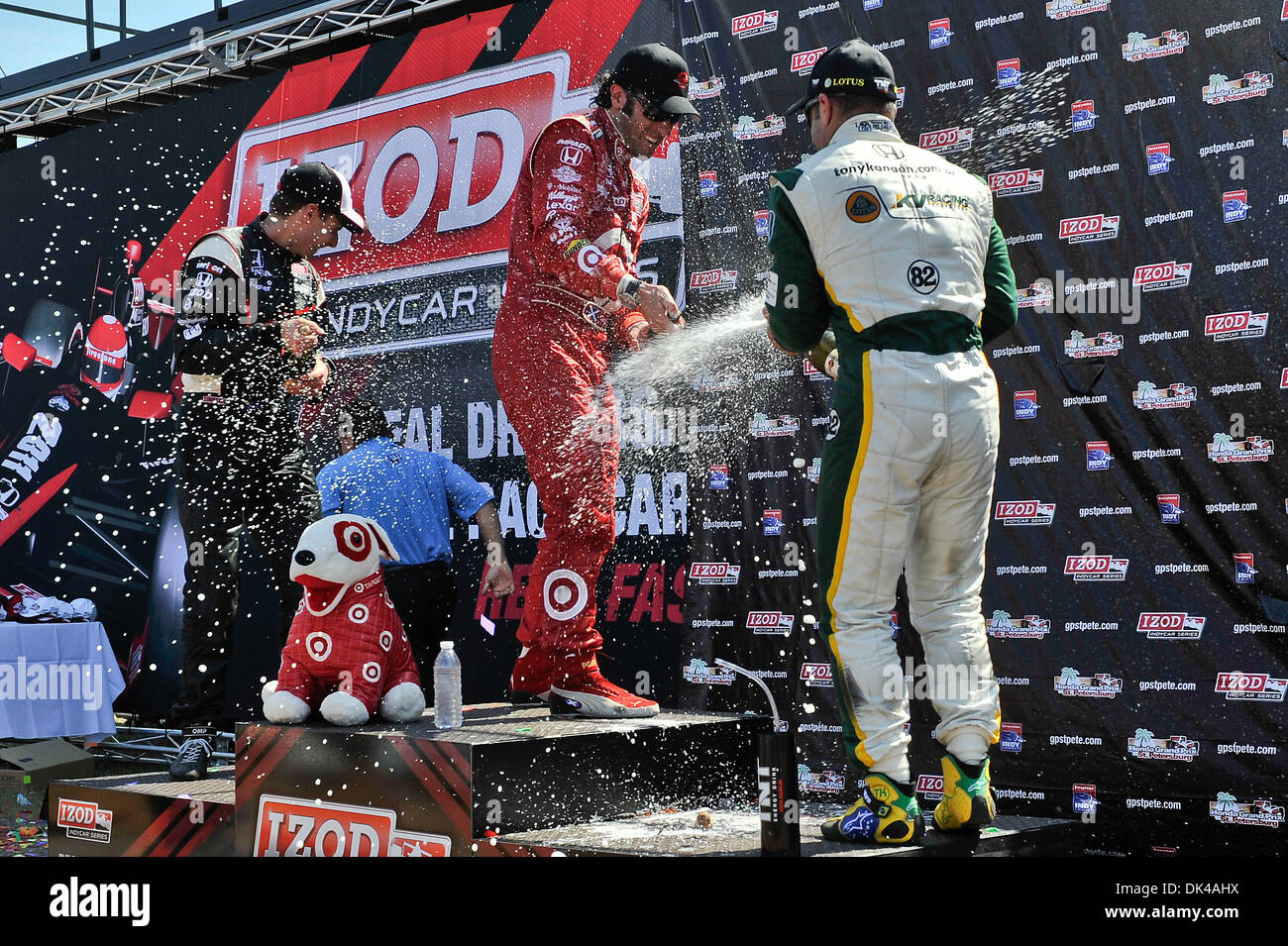 Mar. 27, 2011 - St. Petersburg, Florida, U.S - The traditional champagne salute at the winner's circle (l to r): 2nd place finisher IZOD IndyCar driver Will Power of Team Penske (12), 1st place winner IZOD IndyCar driver Dario Franchitti of Target Chip Ganassi Racing (10), and 3rd place finisher IZOD IndyCar driver Tony Kanaan of KV Racing Technology-Lotus (82) at the conclusion of Stock Photo