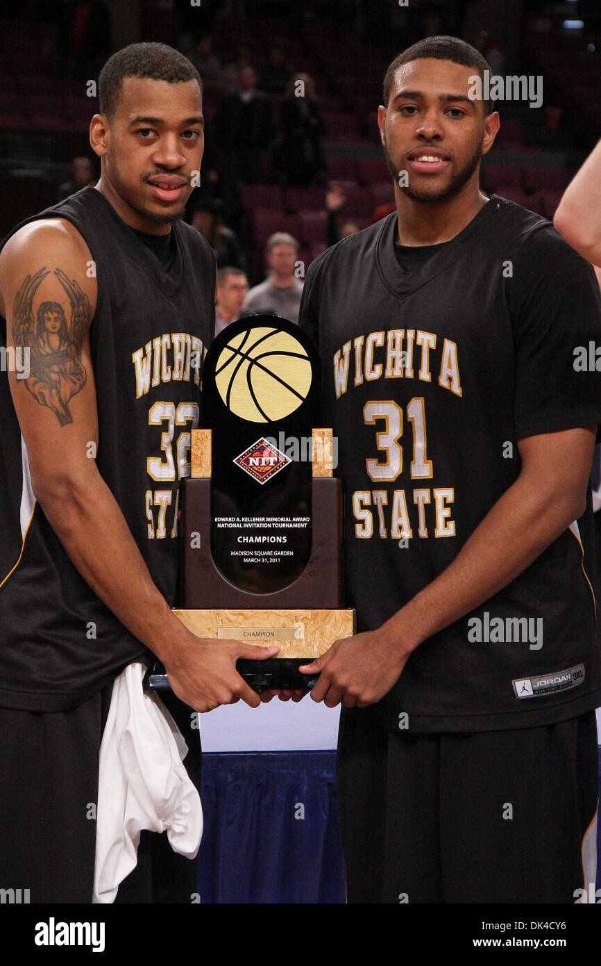 Mar. 31, 2011 - New York, New York, U.S - Wichita State Shockers forward Gabe Blair (32) and forward/center J.T. Durley (31) hold the team trophy after the National Invitational Tournament Championship game at Madison Square Garden in New York, NY. Wichita State defeated Alabama 66-57. (Credit Image: © Debby Wong/Southcreek Global/ZUMAPRESS.com) Stock Photo