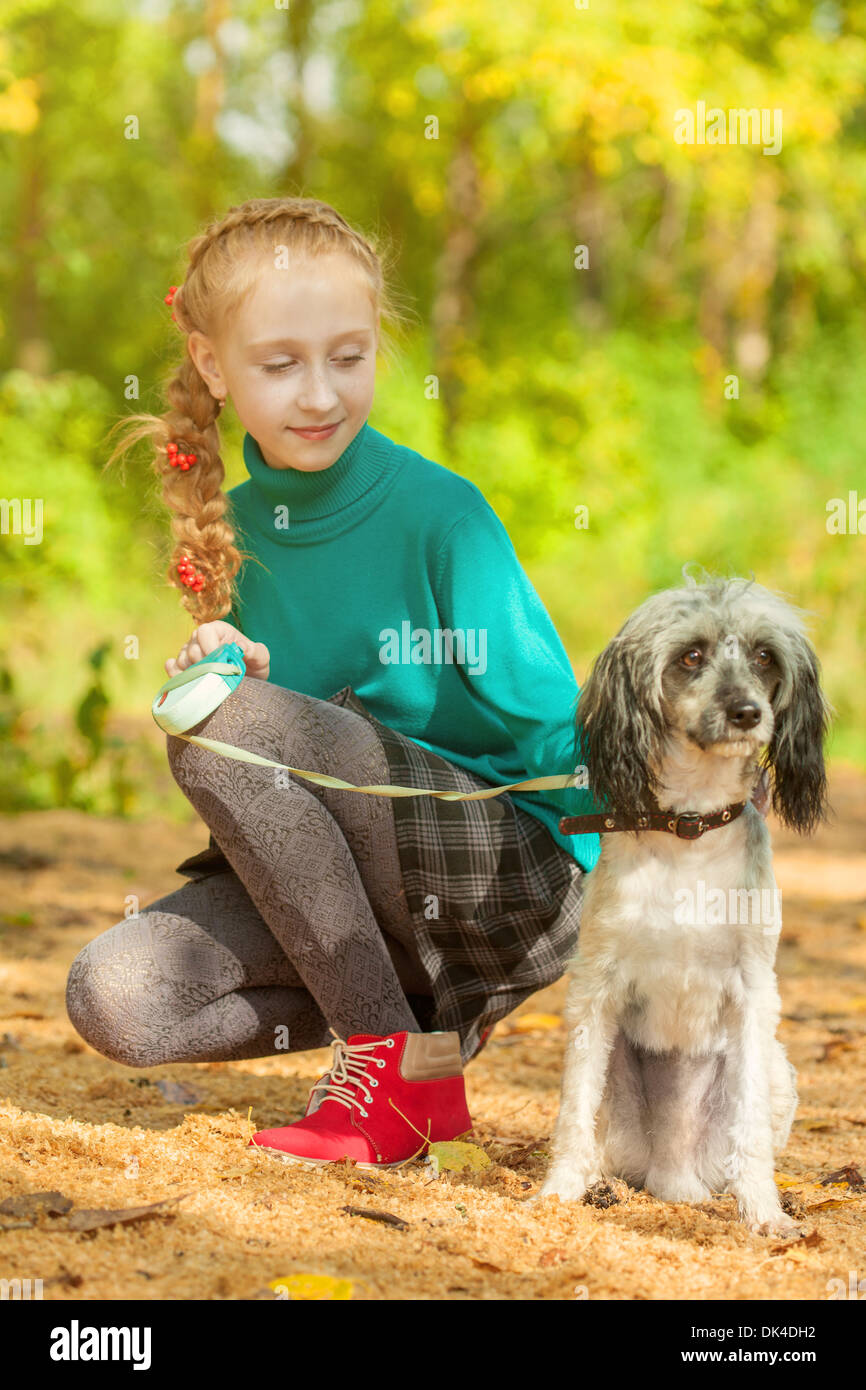 Adorable little girl posing with dog outdoors Stock Photo - Alamy