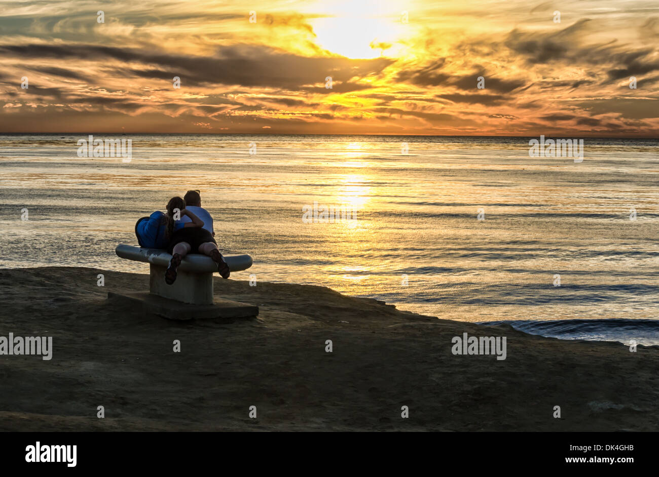 A couple watching the sunset at Sunset Cliffs Natural Park. San Diego, California, United States. Stock Photo