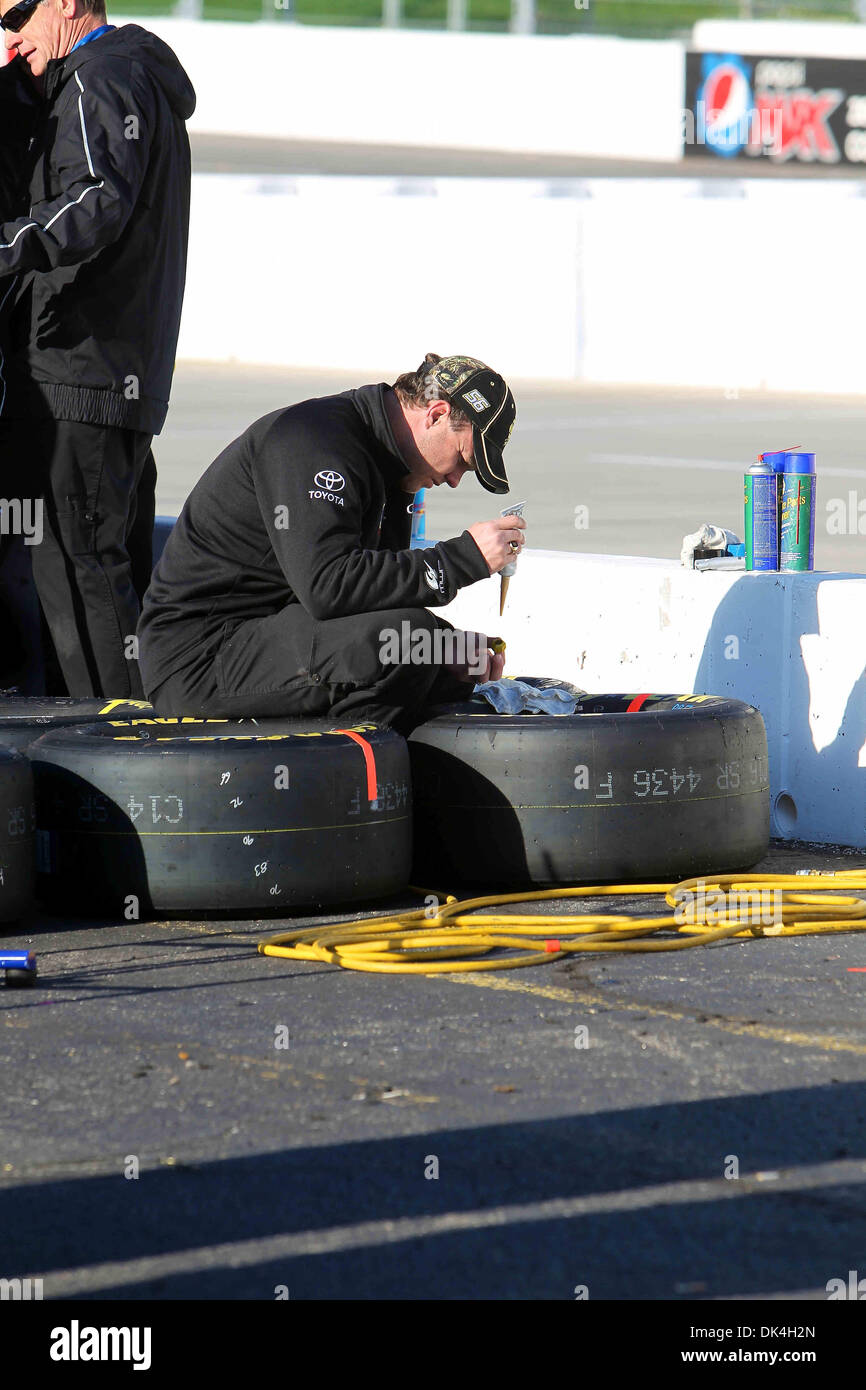 Apr. 3, 2011 - Martinsville, Virginia, United States of America - One of Sprint Cup Series driver Michael McDowell (66) crew members glues the lugnuts to the rims of his tires in the morning prior to the start. Kevin Harvick wins the 62nd annual event with a late two lap charge over Dale Earnhardt Jr. (Credit Image: © Jim Dedmon/Southcreek Global/ZUMAPRESS.com) Stock Photo