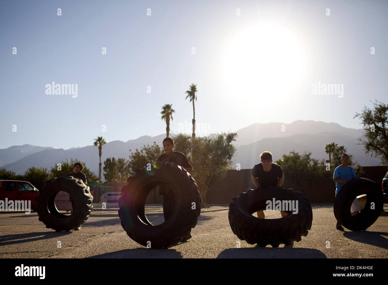Apr. 4, 2011 - Palm Springs, CA, U.S. - Kids warm up in 100-degree weather before a youth boxing tournament by flipping tires through a parking lot Monday, Mar. 28, 2011, at the Palm Springs Boxing Club in Palm Springs, CA. (Credit Image: © Jordan Stead/ZUMAPRESS.com) Stock Photo